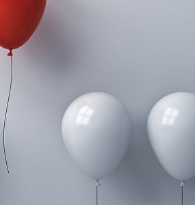 White balloons and one red balloon